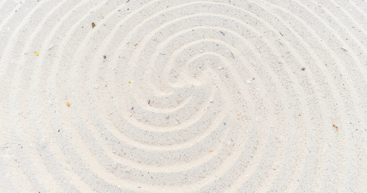 A spiral traced into fine sand